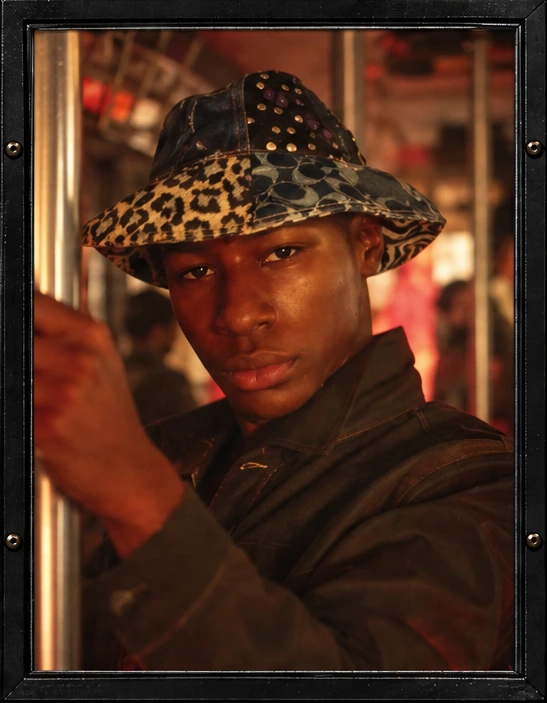 Framed young passenger wearing a patterned bucket hat.